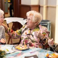 Three women sitting at table chatting
